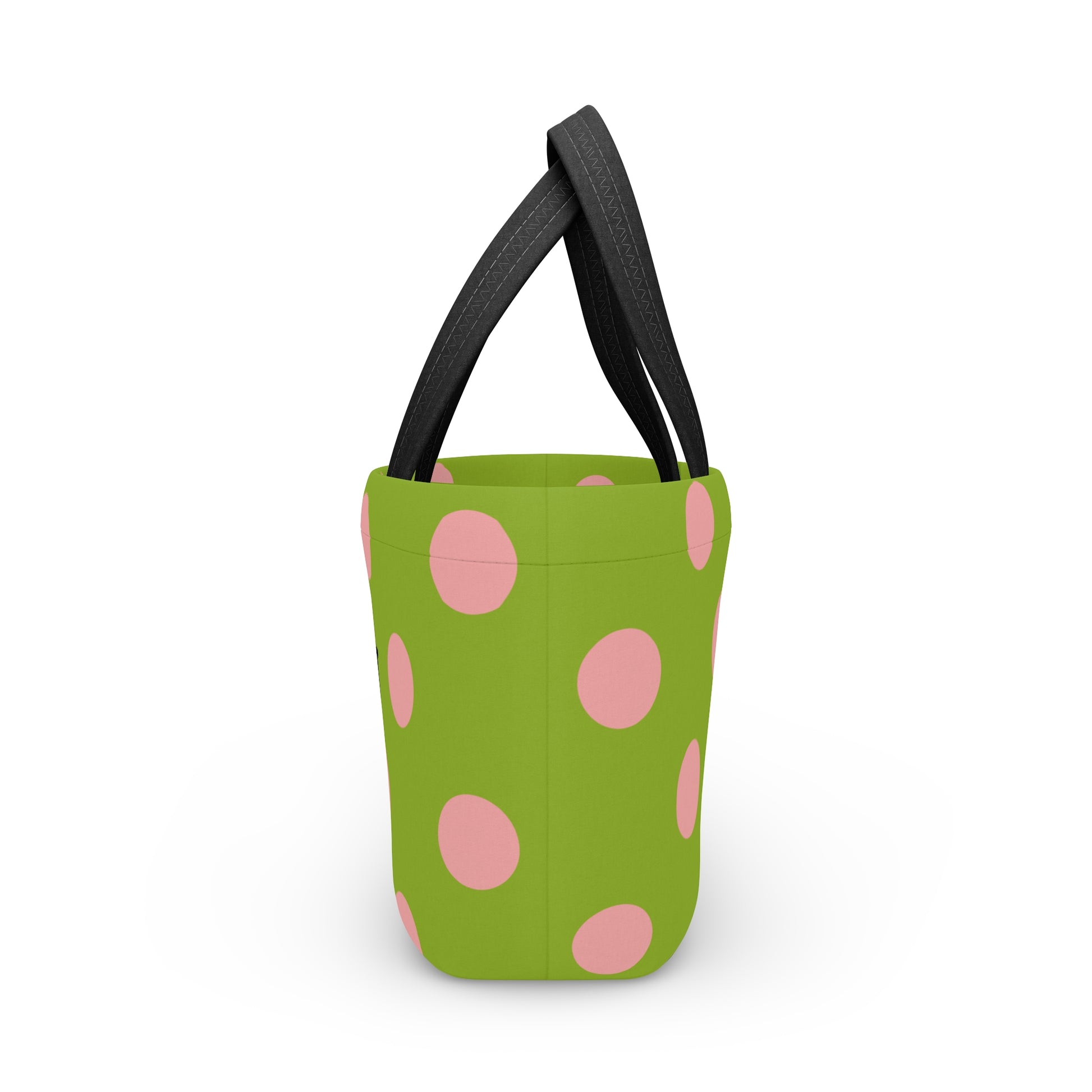 Green bucket with pink polka dots and black handles on a white background