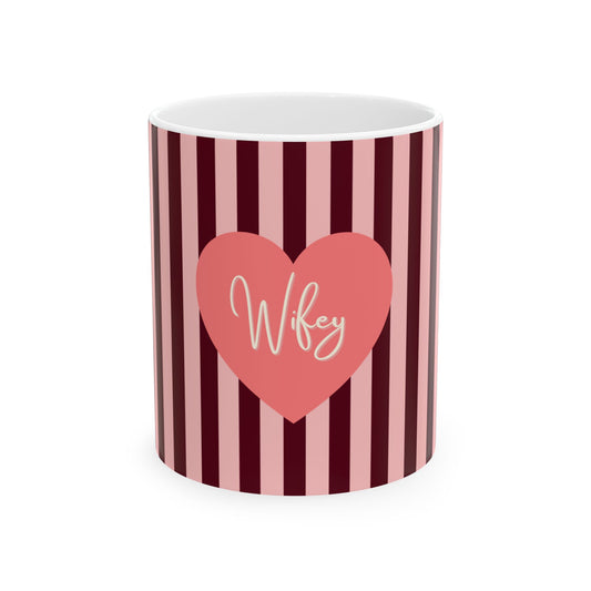 A white ceramic mug with vertical dark red and light pink stripes, featuring a pink heart graphic on the front with the word 'Wife' written in white script.