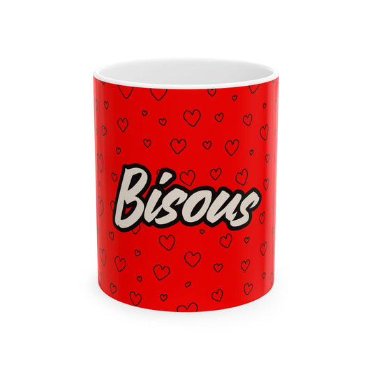 Red mug with 'Bisous' text and heart patterns on a white background