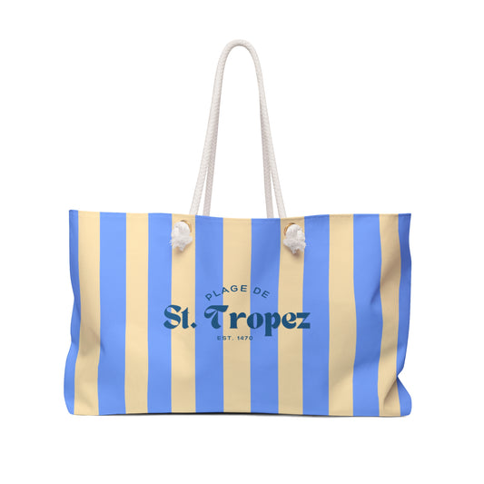 Striped beach bag with 'Plage de St. Tropez' text on a white background