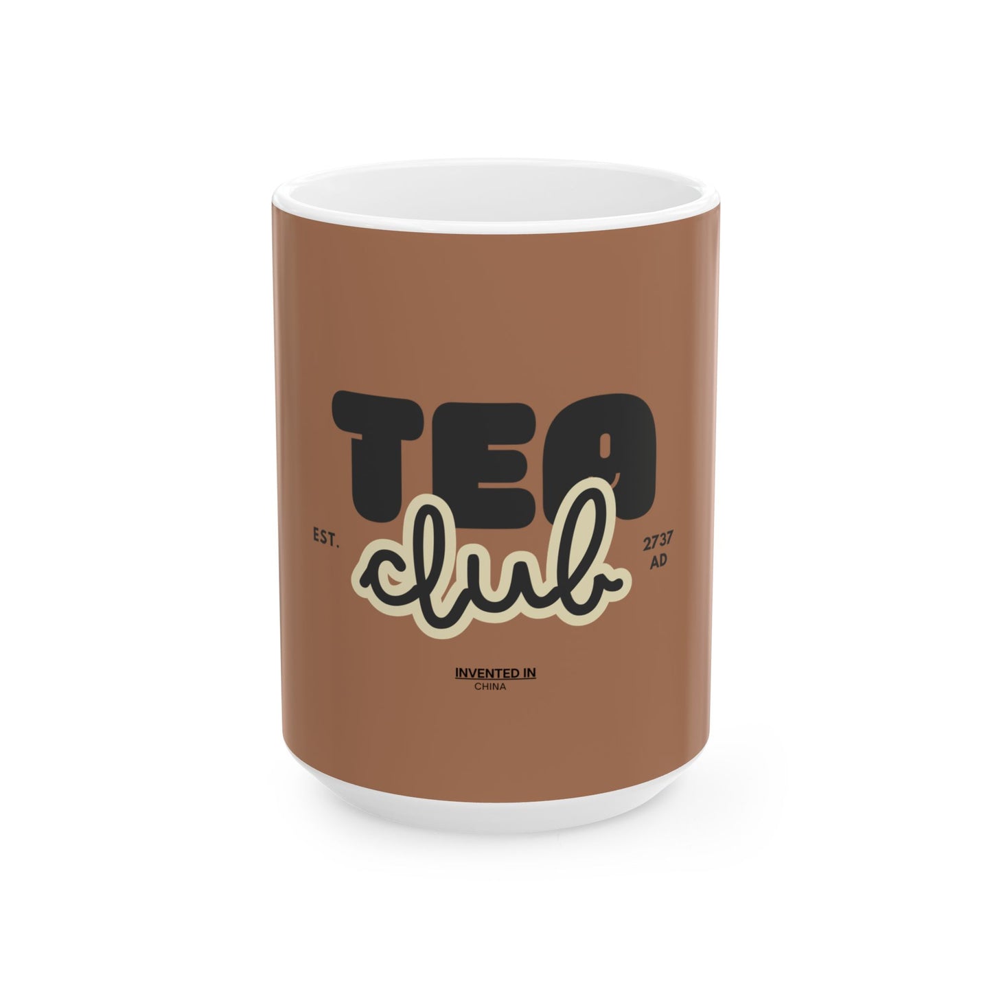 A brown ceramic mug with a white interior and base, featuring a graphic design that reads 'TEA club' in black and cream script, with 'EST. 27th AD' and 'INVENTED IN LONDON' below.