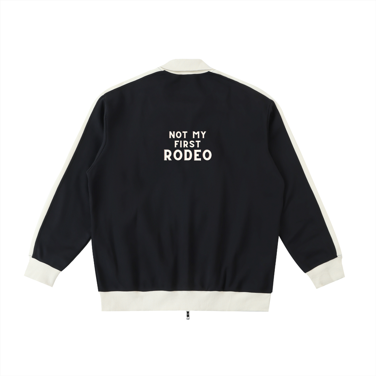 A black bomber jacket with cream ribbed trim and white text on the back reading 'NOT MY FIRST RODEO', shown against a plain white background.
